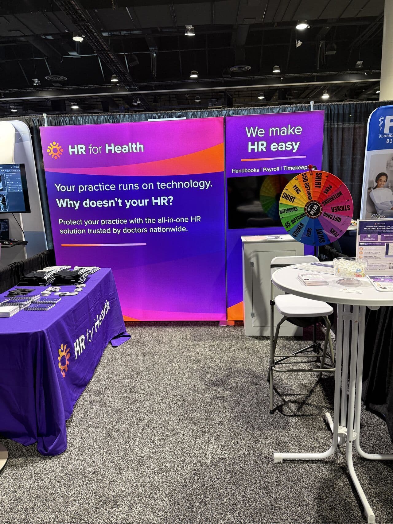 HR for Health trade show booth with a prize wheel and the message Why doesn't your HR?