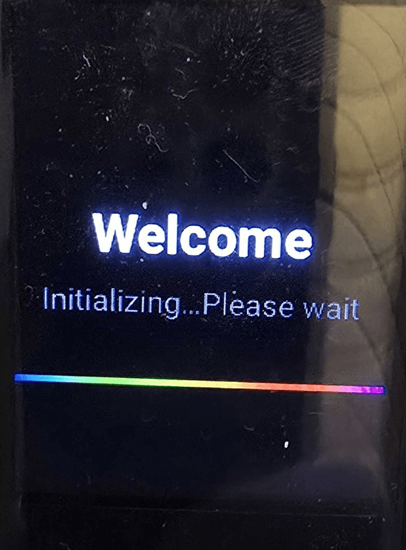 Yealink AX83H handset powering on, showing a Welcome and Initializing please wait screen with a rainbow progress bar